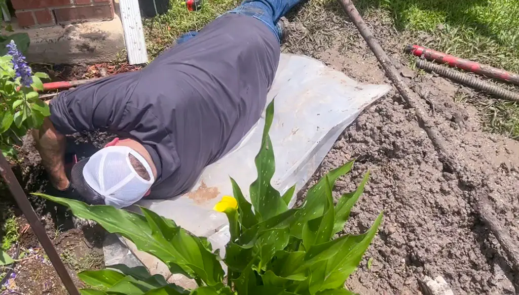 Patriot Plumbing technician repairing an underground water line leak in a San Antonio TX yard