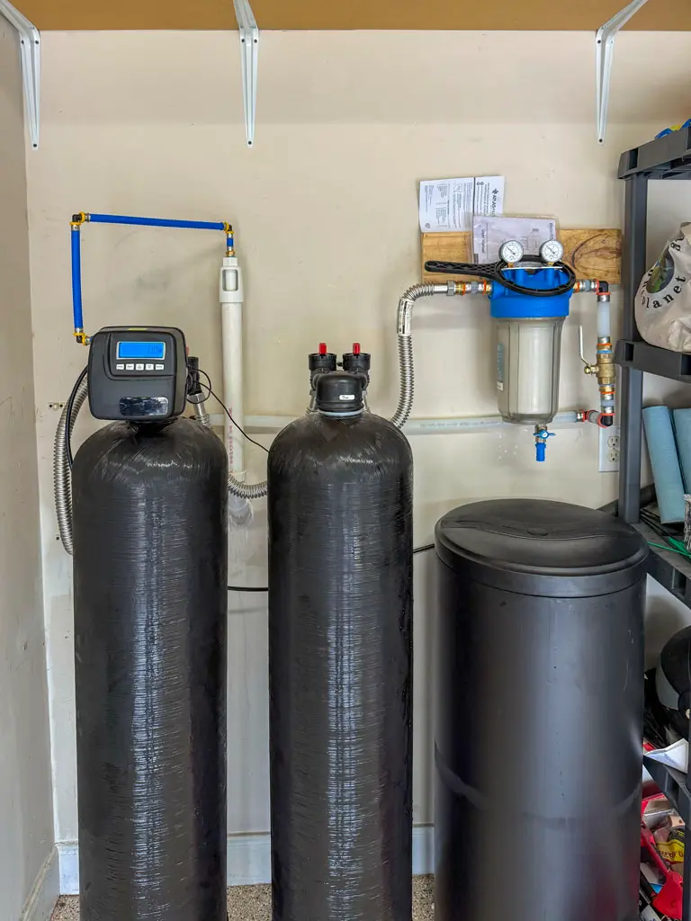 Professional water softener and filtration system installation by Patriot Plumbing in a San Antonio home garage