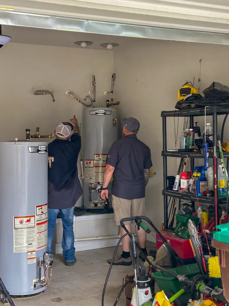 Patriot Plumbing plumbers servicing residential water heaters in a San Antonio TX garage