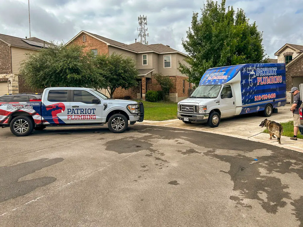 Patriot Plumbing service trucks parked at a San Antonio home ready for plumbing repairs