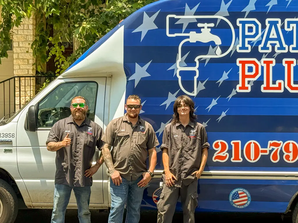 Patriot Plumbing team of licensed San Antonio plumbers standing in front of their service van