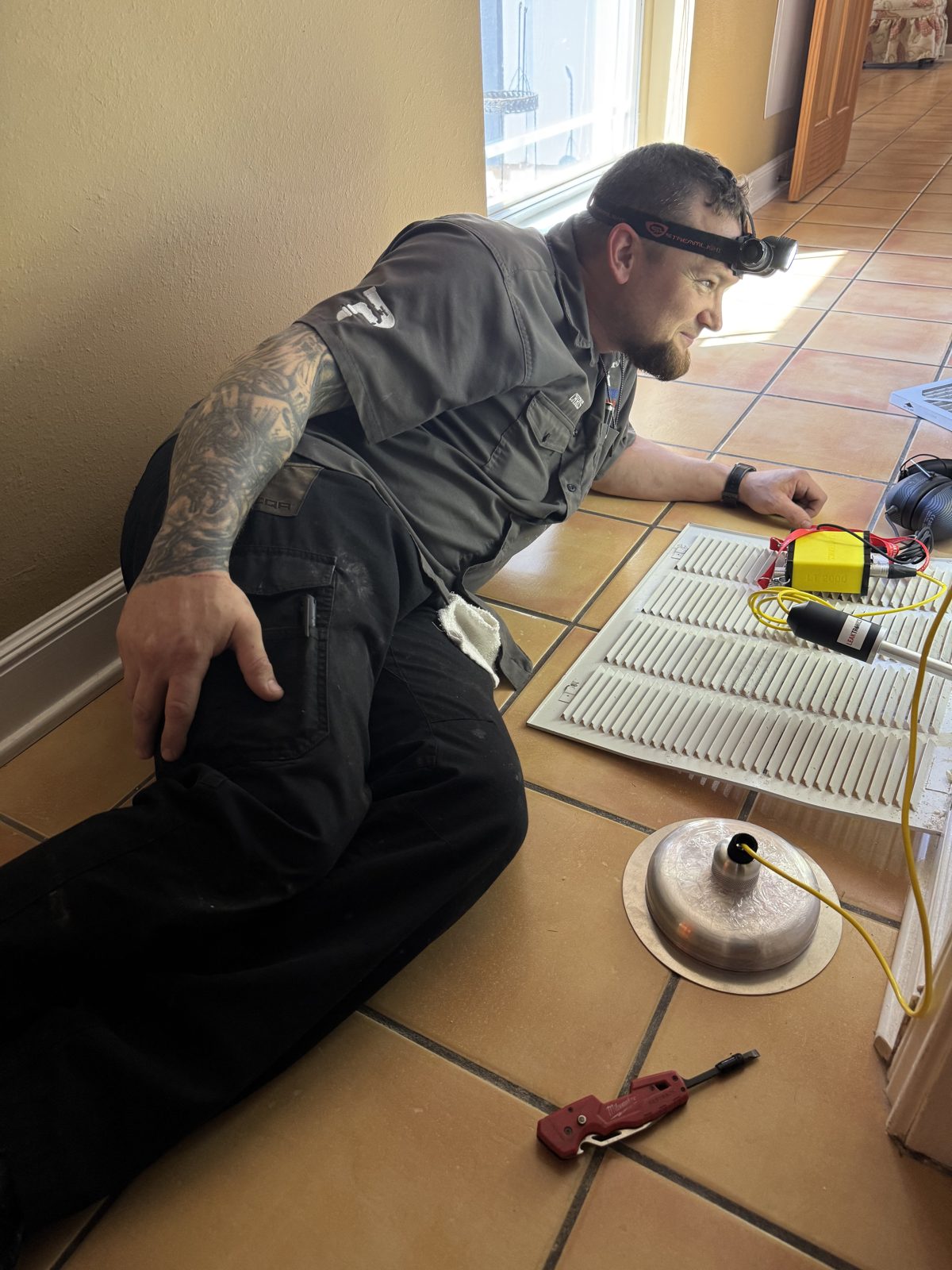 Chris McAnear performing electronic leak detection on a floor line in a San Antonio, TX home