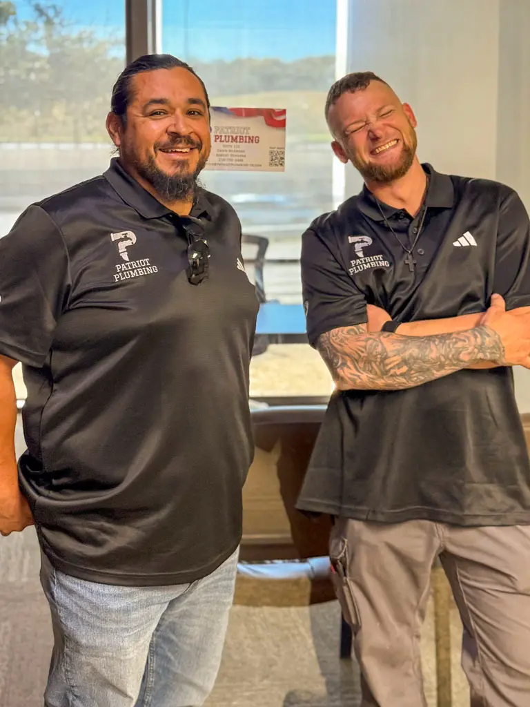 Patriot Plumbing team members smiling in company uniforms at San Antonio TX office